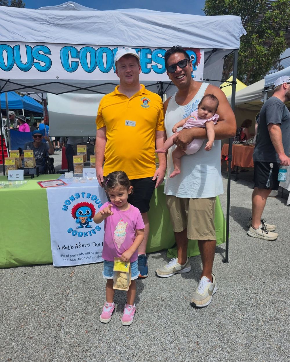 Blissful Seeds artists and family connecting with customers at an outdoor market booth