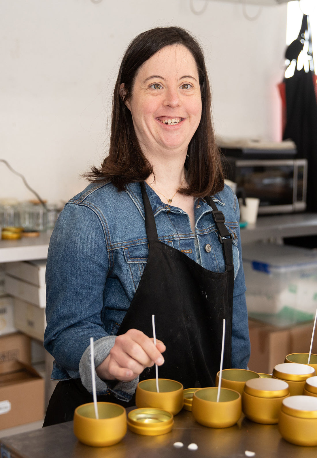 Blissful Seeds artist Amanda hand pouring soy candles in the workshop