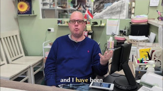 A Blissful Seeds artist talking to the camera at a desk in the studio