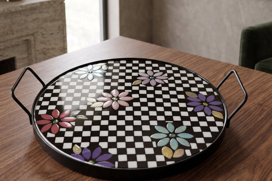 Round Checkered Meadow Mosaic Serving Tray, black and white checkerboard tiles with pastel mosaic flowers, metal handles