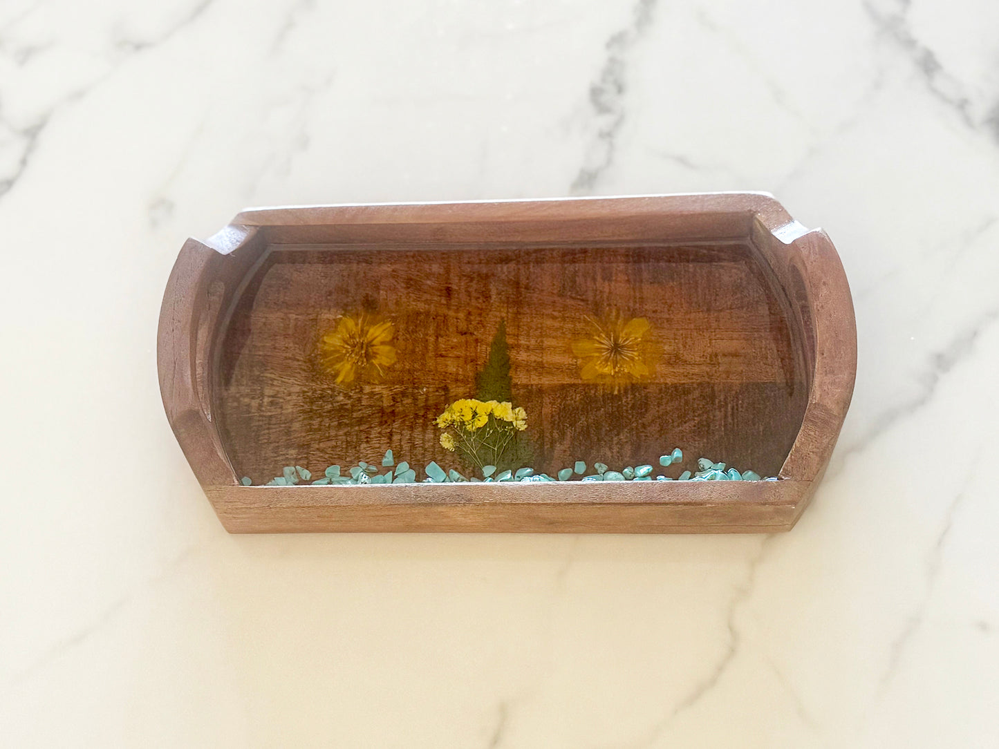 Oblong wooden tray with flowers and rocks
