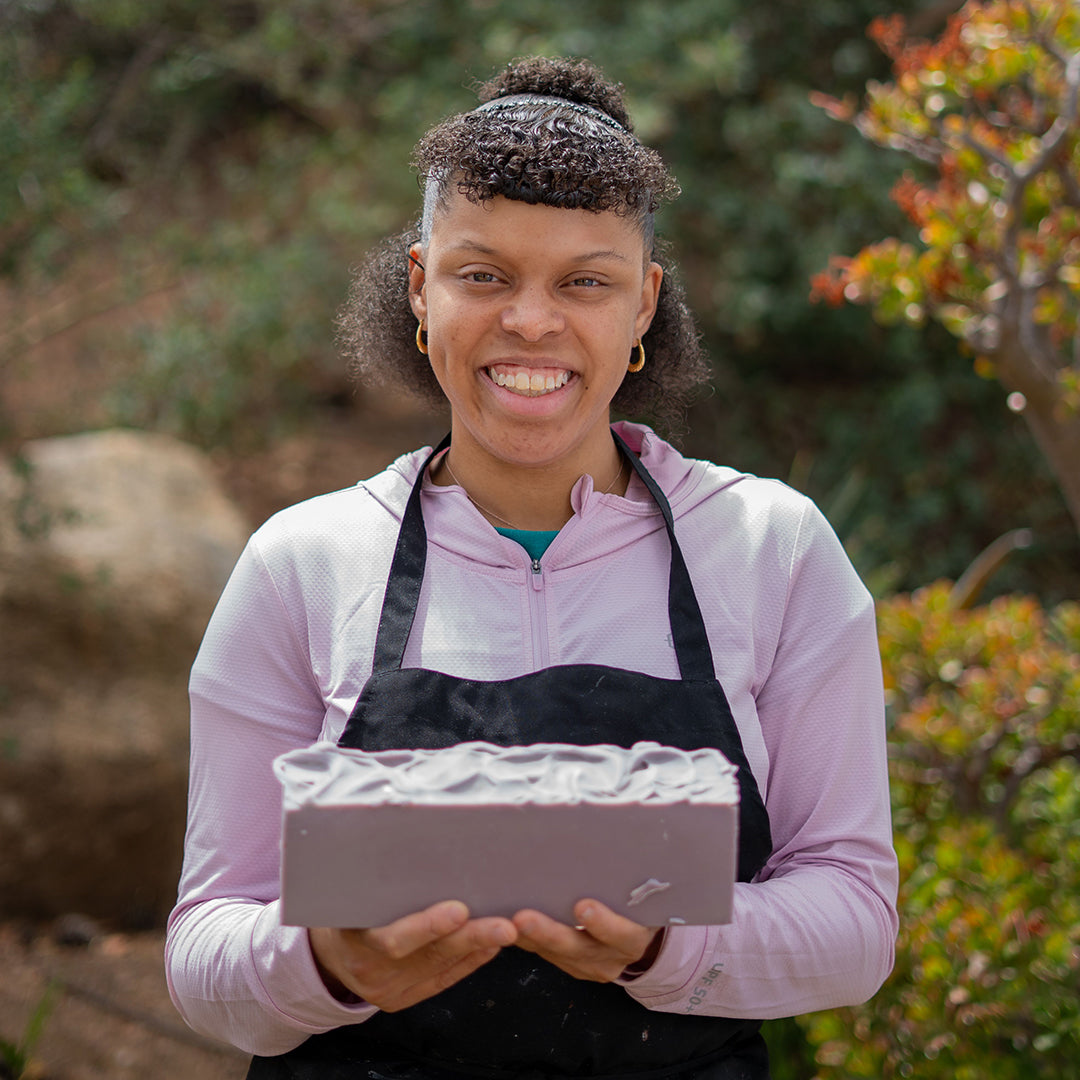 Blissful Seeds artist Krystal holding a bar of her handmade soap